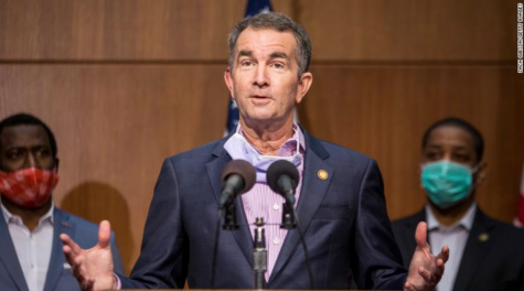 Standing on a podium, Virginia Governor Ralph Northam delivers the latest Virginia reopening plans.