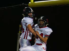 Jumping up, senior Mark Hamilton celebrates with his teammates