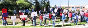 Members of the Jefferson community hold up signs criticizing the merit lottery admissions proposal during a protest on Sunday, Sept. 20, 2020. 