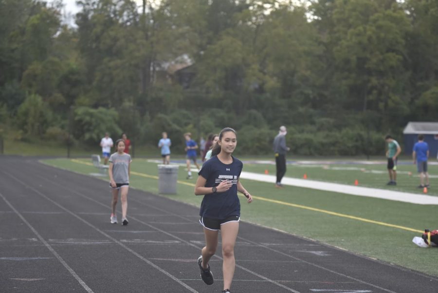 Members of the Jefferson cross country team run on campus during an afternoon October meet. Phase 3 practices kept members in shape during the pandemic. “It’s good motivation to be running two times a week since it’s really hard to find time to do workouts,” Junior Erin Tran said.