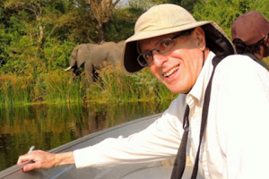 Mr. William Young poses for a picture while on a birding trip in Africa. I find birding to be valuable because it gives you a closer view of nature, Young said.