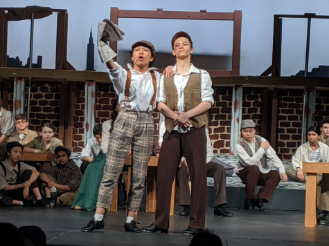 Senior Jenalyn Dizon and Class of 2020 alumnus Andra Velea take a stand in the TJTA’s spring 2020 performance of Disney’s Newsies.  Photo courtesy of tjtheaterarts.com.