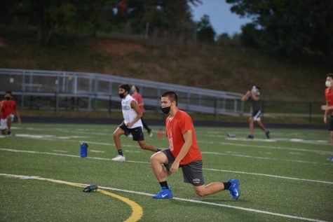Football captain Hilal Hussain participates in warm-ups during a football practice, following distancing guidelines and wearing a mask.  “It’s good to be out there again, even with the distancing; I’m just happy to be playing,” Hussain said.
