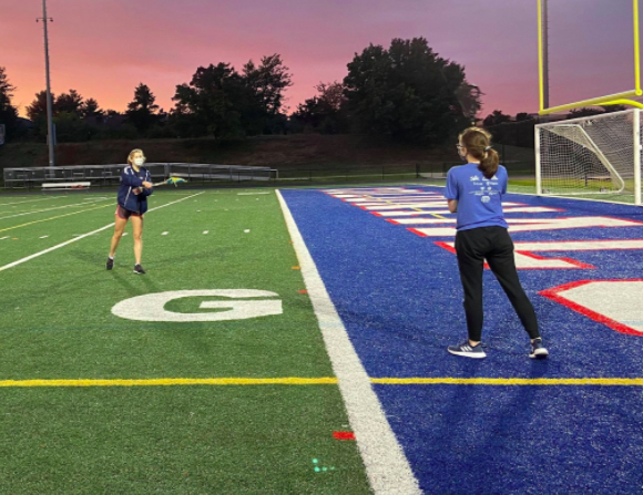 In the midst of a passing drill, seniors Zoe Winston and Anais Beauvais practice lacrosse on the TJ field. Many aspects of usual lacrosse practices have been modified or cut to conform to safety guidelines. “Obviously, we can’t do contact drills anymore,” Granum said. “We can’t be near each other and we wear masks all the time.”