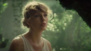 Taylor Swift gazes up at the clouds in the music video of “Cardigan”, a song in her latest album, “Folklore”.