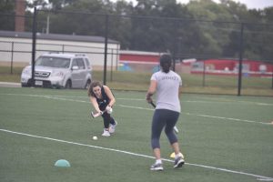 Jefferson Field Hockey players practice drills in COVID-adapted green day practices. The one-on-one passing drill is meant to improve skill while staying safe. “The passing drills are used to have smooth hand eye-coordination on the field, however the highlight of practice are the shooting drills,” said freshman Tessa Joseph. 