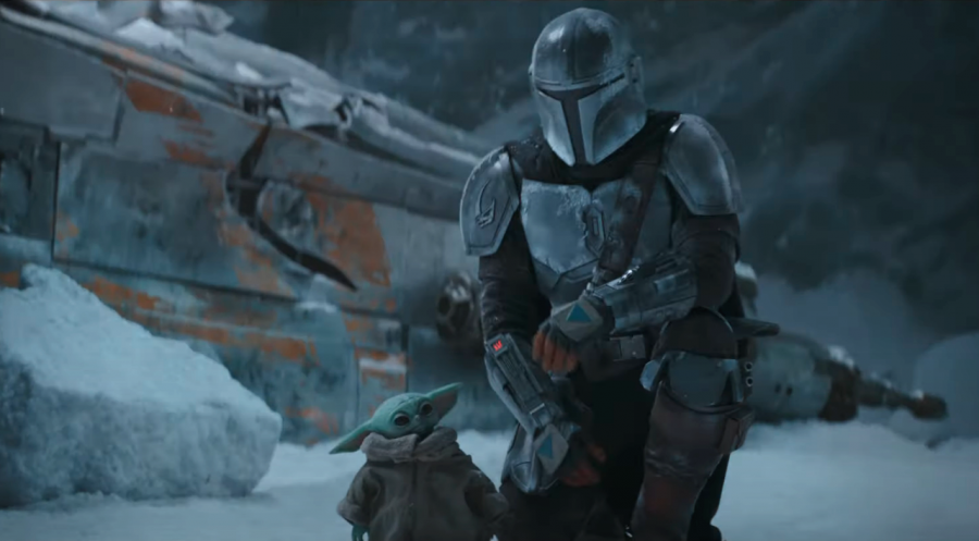 A scene from the second episode of The Mandalorian shows the protagonist walking alongside a younger Yoda. 