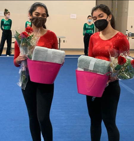 Seniors Navya Vargese (left) and Lisa Raj Singh (right) receive flowers and gift baskets at senior night.