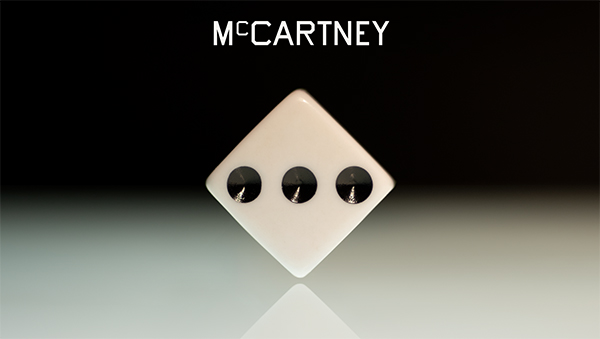The album cover for “McCartney III” is a typographic painting by artist Ed Ruscha, focused on the face of a dice showing the number three.