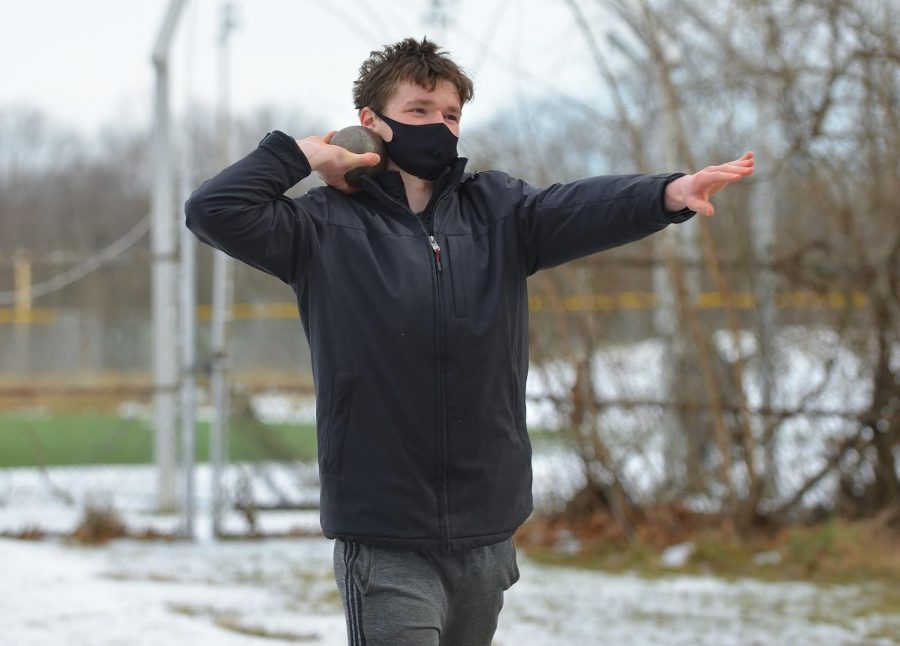 Junior David Lyons practices a shot put throw for track and field. “The only way [winter sports] could've been better is if we didn't have to work around COVID, so the only way to improve them would be for everyone to be COVID safe,” Lyons said.