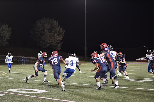 Colonial players prepare to bring down Centurion player (3) running down the field for a first down.