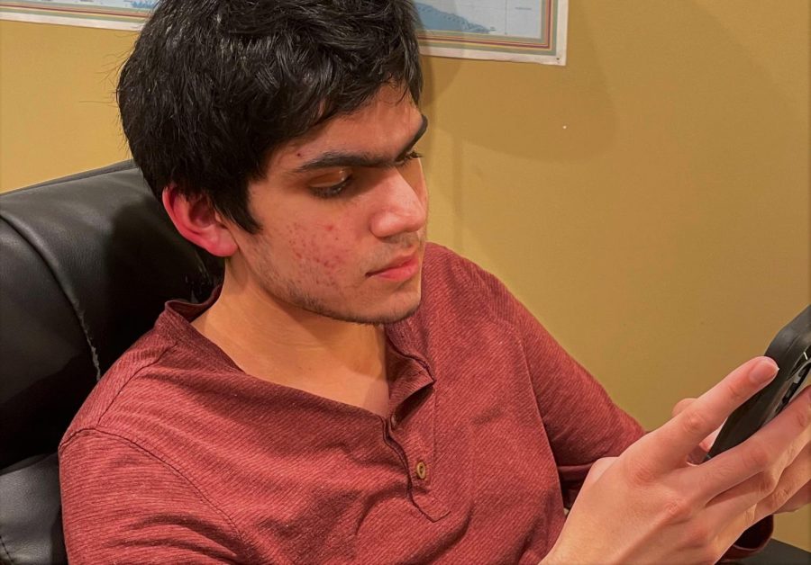 Junior Zach Shah stares at his phone screen, scrolling through Instagram to pass the time. 