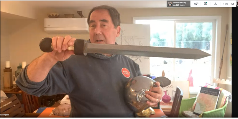 Guest speaker Richard Campbell shows off a standard Roman military sword and helmet. “This is a mid-century Pompeii gladius, named because so many were found in Pompeii during excavation,” Campbell said. 