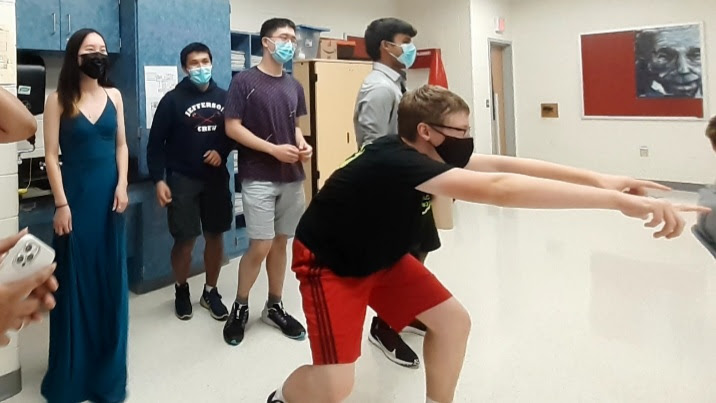 Seniors Spencer Miller (main), left to right- Hailena Bian, Akash Piya, James  Xu, Akash Pamal spirit bomb an AP Chemistry class during Homecoming week. A long-time tradition at TJ, students are finally able to get back into spirit bombing.“Spirit bombing is a really fun way to get hype during hoco week and release a ton of energy,” Akash Pamal said.
