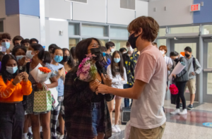 Sophomore Richa Dhakal holds flowers from sophomore Kaan Eguz’s asking.