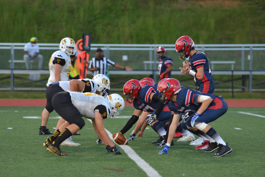 Senior Oliver Tu and the rest of Jefferson's defensive line face off against the FCA Bucks early in the game.