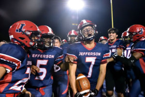 Junior running back Justin Yoo (7) celebrates after scoring the winning touchdown.