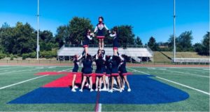 The TJHSST cheer team practices together on the football field. ”I think the community of people who are in cheer is really fun and laid back, and everyone’s super supportive,” senior Justine Chu said.
