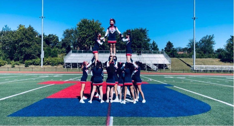 The TJHSST cheer team practices together on the football field. ”I think the community of people who are in cheer is really fun and laid back, and everyone’s super supportive,” senior Justine Chu said.