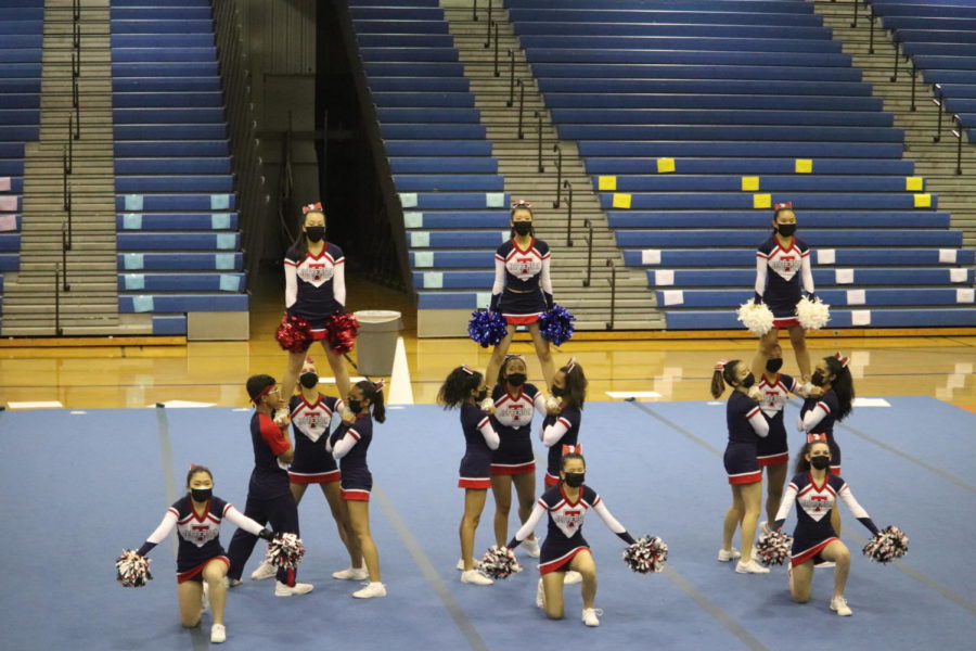The Jefferson cheer team performs at the National District Finals Competition on Oct. 16. "I'm really proud of our team for accomplishing our routine." Julia Zherdetski said.