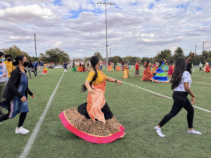 Students wear Indian clothing and dance together in circles at Namaste’s Garba celebration. “I really liked the dancing since it was pretty chaotic. Sometimes people would be scrambling to get to the next move, but it was fine because you could lose yourself in the music. You really got to enjoy yourself since the movements were energetic,” sophomore Neha Asuri said.