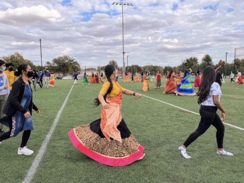 Students wear Indian clothing and dance together in circles at Namaste’s Garba celebration. “I really liked the dancing since it was pretty chaotic. Sometimes people would be scrambling to get to the next move, but it was fine because you could lose yourself in the music. You really got to enjoy yourself since the movements were energetic,” sophomore Neha Asuri said.