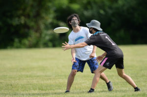 At the 2021 Virginia High School State Competition, senior Kareem Jaber rifles the frisbee past a Marshall High School player. “The main thing about [ultimate frisbee] is just having fun. There’s not as much competition [as] there [is] sometimes in football or other sports,” Jaber said. 