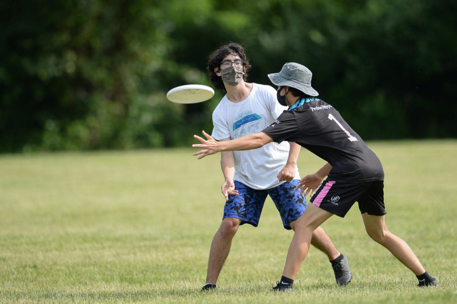 At the 2021 Virginia High School State Competition, senior Kareem Jaber rifles the frisbee past a Marshall High School player. “The main thing about [ultimate frisbee] is just having fun. There’s not as much competition [as] there [is] sometimes in football or other sports,” Jaber said. 