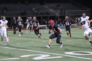 Junior running back Justin Yoo carries the ball across the 20 yard line. The varsity football game originally scheduled for this Friday, October 22, was moved to October 21 at 7 p.m. due to a referee shortage. “I was really excited that we ended the season on a good note,” Yoo said, “but [it was] also sad that it was our last game with the seniors.”