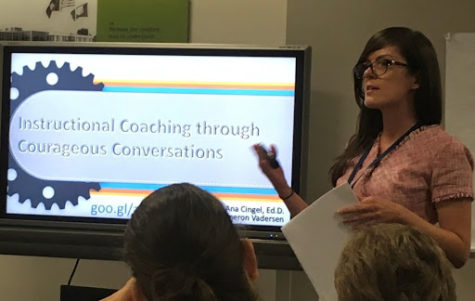 Dr. Ana Cingel presents insights on teacher-to-teacher conversations at a staff training meeting.