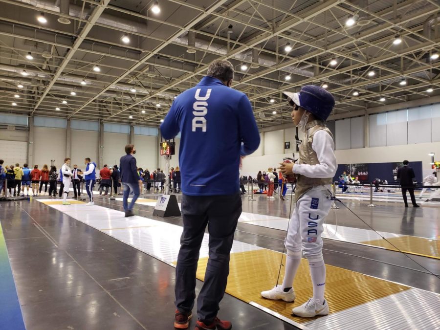 Freshman Aidan Lee talks to fencing coach Greg Massialas during the individual competition portion of his tournament. Lee competed in the Cadet Individual and Team Men’s Foil Event in Budapest, Hungary from Nov. 13-14. “In individual, I got second after the first round. I was winning 13 to 11. I just messed up and I lost,” Lee said. 
