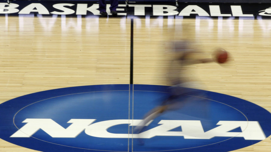 Kansas State's Adrian Diaz streaks across the NCAA logo at midcourt during basketball practice in Pittsburgh, Wednesday, March 14, 2012. Kansas State plays against Southern Miss in an East Regional NCAA tournament second-round college basketball game on Thursday. (AP Photo/Keith Srakocic)