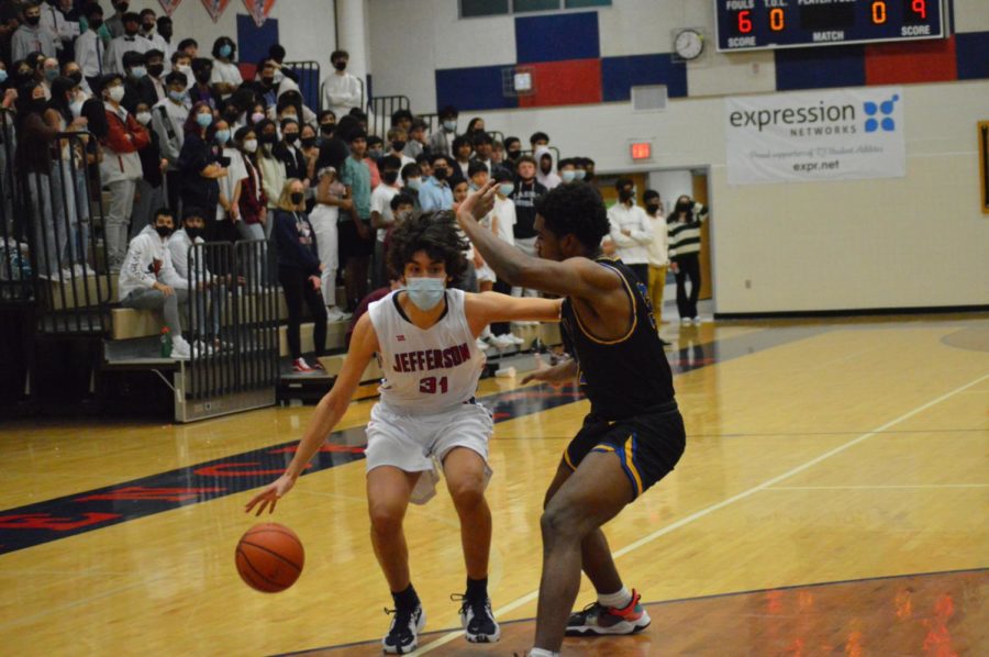 Sophomore Santiago Criado is seen defending against one of the Lewis Lancers. With their game against the Lancers being the last of the season, Criado reflects on his experiences this season, “It was just really great to be able to have a place where you would meet with people every single day to do something you love to do. I feel like the basketball team is such a tight knit community,” Criado said.