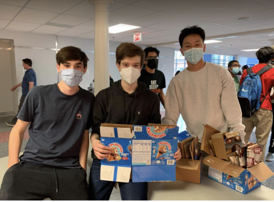 After they sold out of ice cream, Class Council members Felix Howton, Matt Sprintson, and Tommy Fan hold up boxes of empty ice cream sandwiches, cones, and bars. “We’re definitely looking to replicate the same success in the future,” sophomore Matt Sprintson said. 