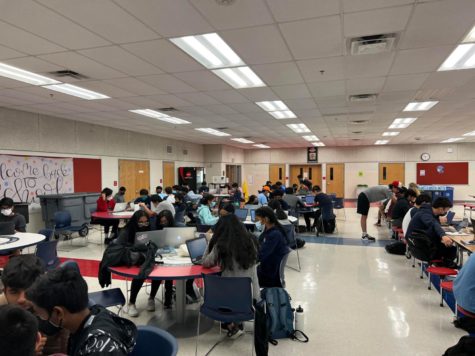 Students work on solving the competition’s coding problems in the school’s cafeteria.