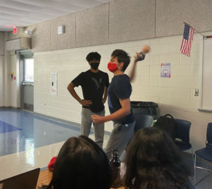 Freshman Deven Hagen throws a fake baby prop in mock rage during his insult performance against freshman Rishi Roy during the final round of the tournament. 