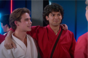 Robby Keene (Tanner Buchanan) and Miguel Diaz (Xolo Maridueña) speak to Johnny Lawrence (William Zabka) together a few episodes after forming a new friendship. The two have a long history of rivalries due to Robby being Johnny’s son and Miguel seeing him as a father figure. 