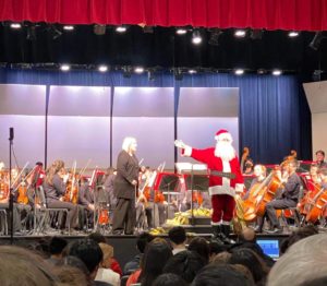 Near the end of the concert, a parent dressed as Santa joins the students on stage during “Sleigh Ride”. “He came up with this idea because it's right after the holidays, and then it's a winter concert. We're still in the Christmas spirit,” TJ Orchestra Boosters fundraising chair Chihyon Yi said. 