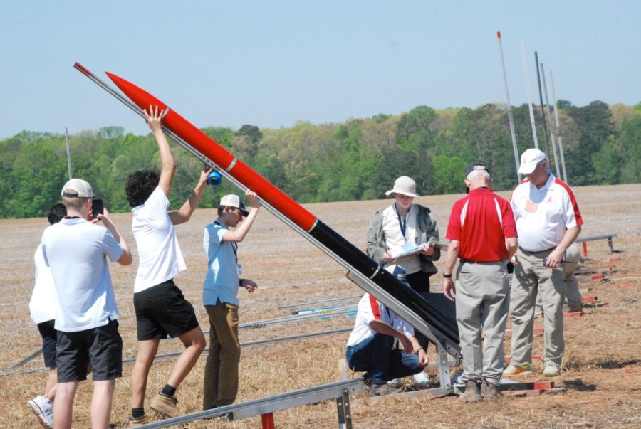 Juniors George Evanisko, Santiago Criado and Larry Schrag and sophomore Deen Nori set up the rocket before the launch. “A big misconception about this program is that most of the effort is in building the rocket or the payload. I would argue that most of the work, literally hundreds of hours, was spent designing and planning prior to building anything,” Criado said. 