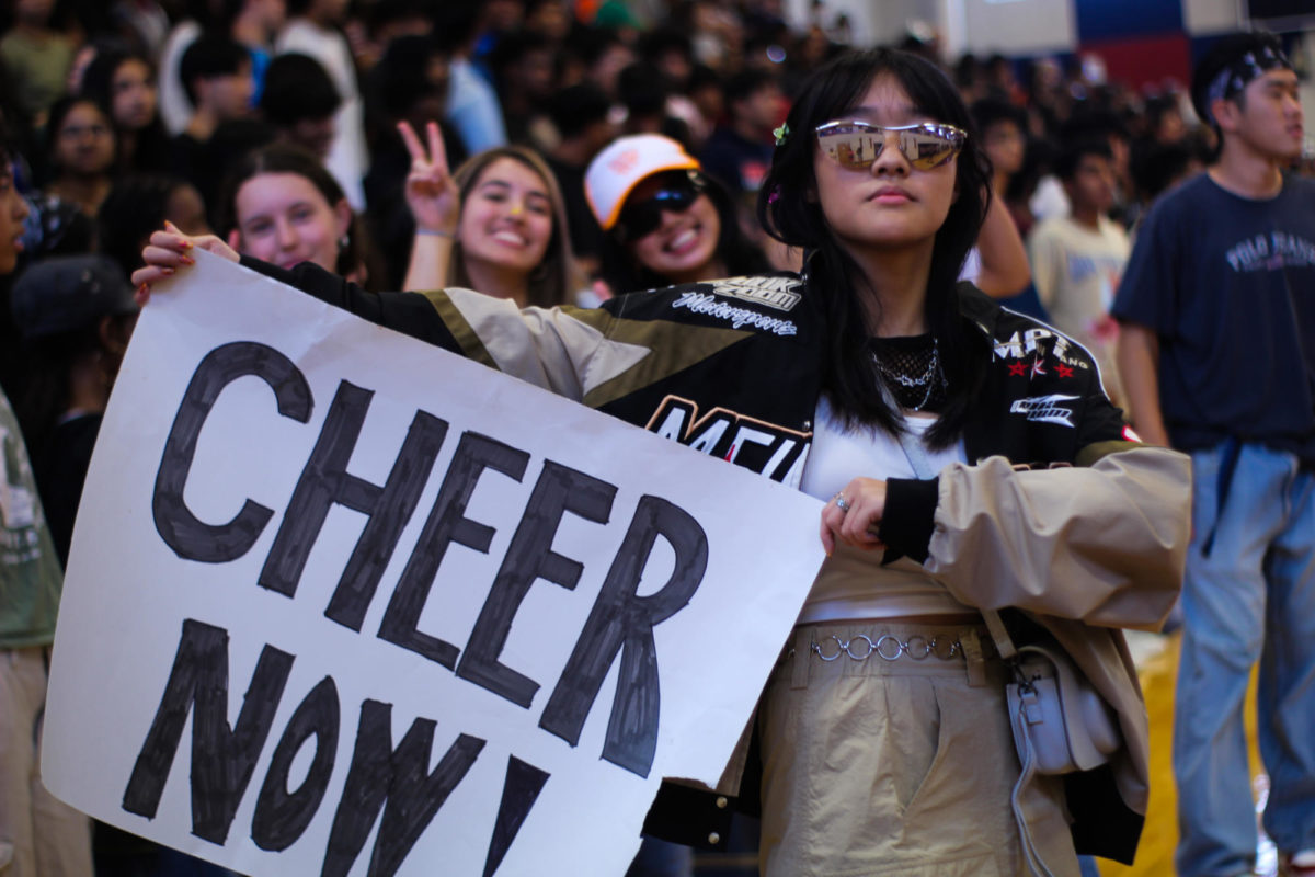 Dressed in her class theme of Y2K, sophomore Jocelyn Huie displays a crowd-made sign during a lunch pep rally. “I’m really into fashion in general, so when we found out our [theme] was Y2K, I was already thinking of what I was going to wear,” Huie said. “Some people thought I was just wearing a regular outfit in my classes because I wear that kind of stuff in general.” 