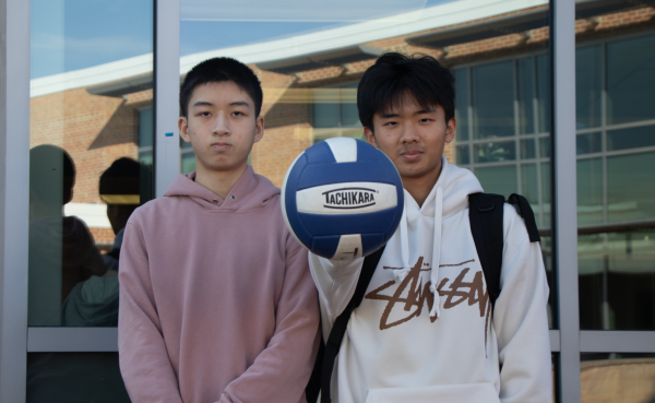 Palming the ball, freshman Tony Wang stands with sophomore Eric Cai, representing a part of boys' volleyball. “The club has gotten more teams and gotten more competitive. But it [has the bandwidth to] become [even] bigger and become a real sport,” Wang said.