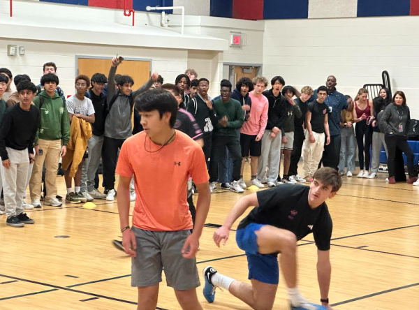Amidst the crowd, sophomore Owen Davenport and junior Derek Deconti watch as the soccer ball nears the net. “I could always hear our friends cheering wherever we scored which was nice to have so much support and also pumped us up to play”, said DeConti. 