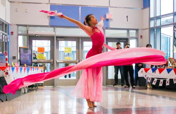 Sophomore Holly Huang twirls a ribbon as she performs her dance, “Joy of the Dragon.” Chinese ribbon dance is a traditional art form originating in ancient China. Her ribbon dance was inspired by the revered mythical creature and this year’s Chinese zodiac sign, the dragon. “My ribbon symbolized a dragon flying in the air. My outfit was [also] inspired by the dragon, the color was the same color as my ribbon, but on the shoulder there were some details like dragon scales,” Huang said. “I liked how there were a lot of people in the audience and it was just really fun to perform.”