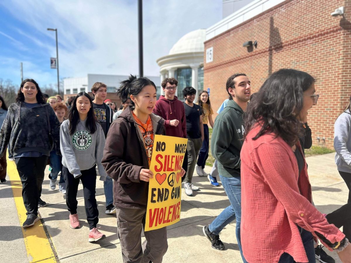 Walking out in protest, sophomore Kyungsup Hwang holds up a sign, which says ‘No more silence. End gun violence.’ “We had this moment of silence series where weve posted every day for two weeks leading up to this walkout about victims of gun violence. I helped write the bios, researched about them, and also worked with the outreach committee who found the names of people and the information about them,” Hwang said.