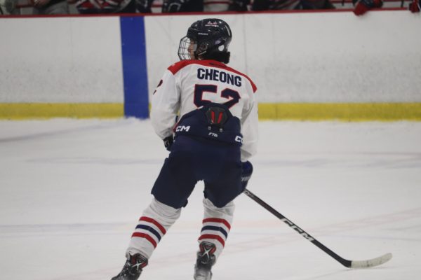 Senior Aiden Cheong skates on the ice during a game against the Reston Raiders. “I don’t think about anything else; I just focus on the game and playing my best. I try not to let any distractions get to me,” Cheong said.