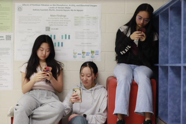 Juniors Grace Sharma and Hannah Liu along with senior Laura Zhang mindlessly scroll on their phones in Turing Commons instead of being present in the moment. 