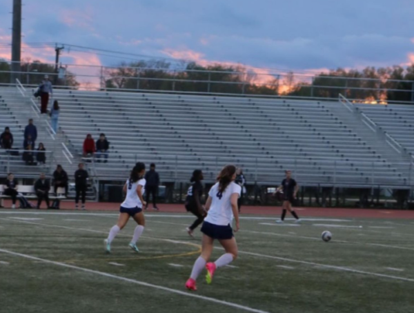 Senior Aurora Zary and junior Anna Chau run after the soccer ball as they move into the opposing team’s half. “It was definitely a game to be remembered, and I think it’s just a reflection of how hard we all have been working,” junior Josie Clayton added.