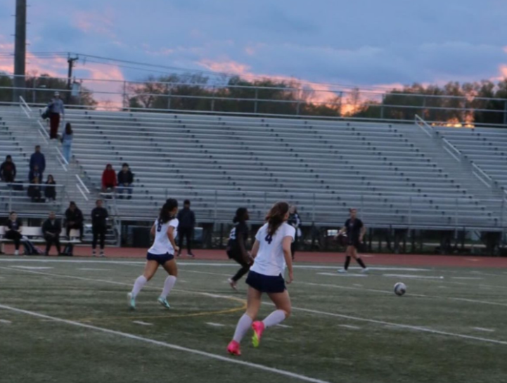 Senior Aurora Zary and junior Anna Chau run after the soccer ball as they move into the opposing team’s half. “It was definitely a game to be remembered, and I think it’s just a reflection of how hard we all have been working,” junior Josie Clayton added.