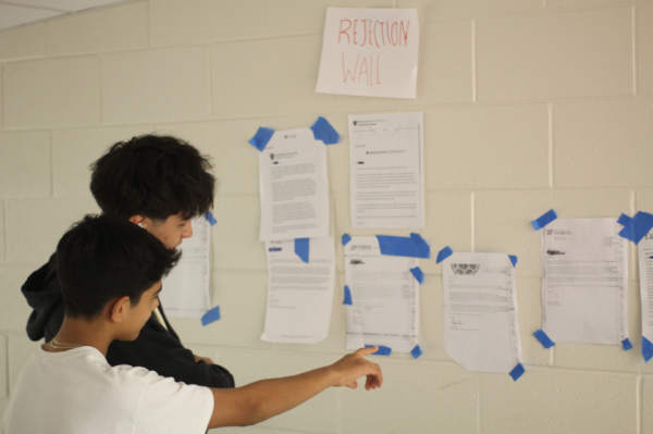 Freshman Ronald Saba and sophomore Brian Bowers read the sparse rejection letters together. “I really like the idea of having a Rejection Wall here at Jefferson. It unites students with their struggles at a school that is very competitive,” Saba said.