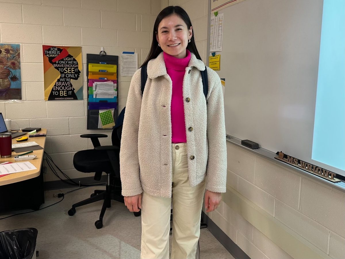 History teacher Gwen Wright smiles in a thrifted wool sweater of her signature color: bright pink. “I love thrifting clothes,” Wright said. “It’s probably where I get a good amount of my clothes. It's affordable, which is great, but it's also sustainable. Thrifting is a really fun hobby because you just never know what you're gonna find.” 